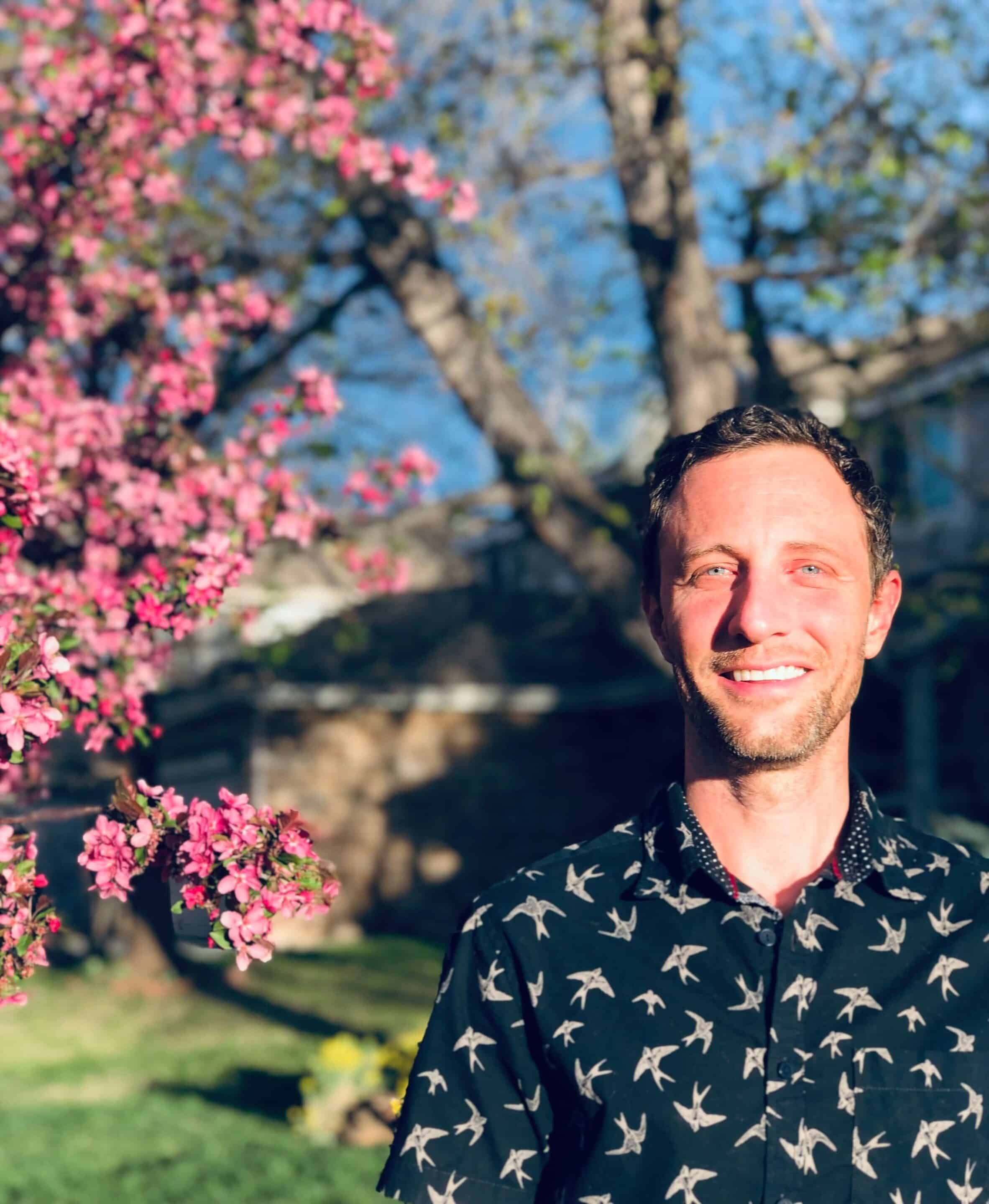 PRATI foundational course director Stephen Thomas standing in front of a tree with blossoms