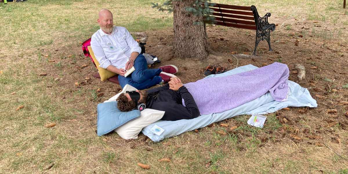 image of someone journeying outside under a tree